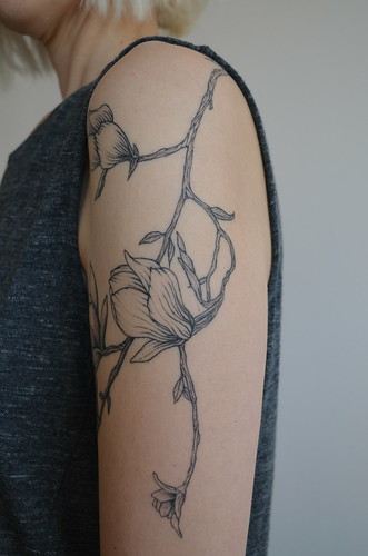 Brücius floral magnolia tattoo down side of arm