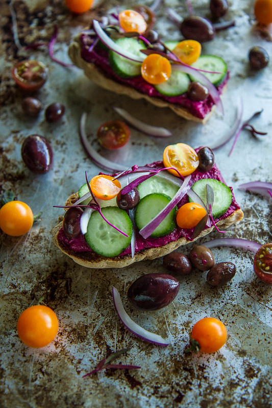 Toast with Beet Hummus, cucumbers, tomatoes and olives