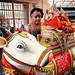 A Hindu priest secures statues of deities on a bull