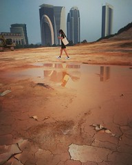 Girl walks through wasteland in a post apocalyptic world