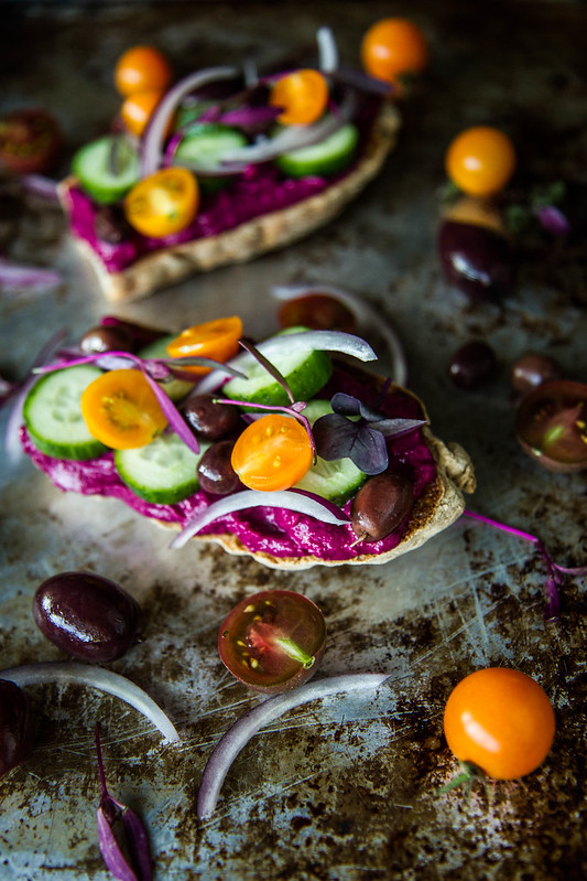 Toast with Beet Hummus, cucumbers, tomatoes and olives