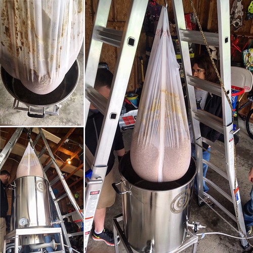 Lifting 50 lb. of pils malt on @aaronritchiebrewing's monster #BIAB system. #homebrewing