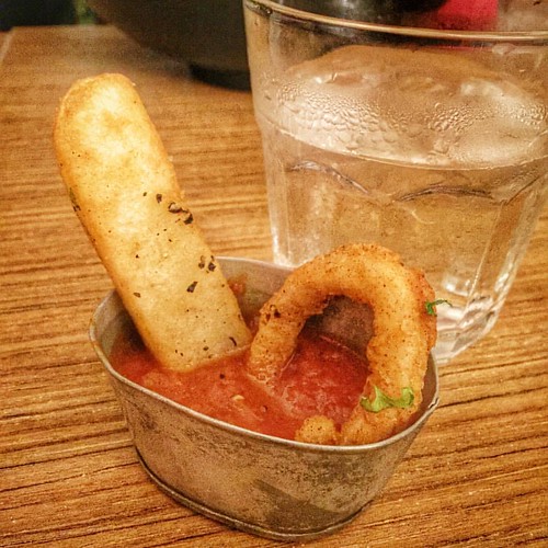 Just chillin'. A truffle fry and a calamari ring taking a dip in a tub of salsa sauce. #kravecafe