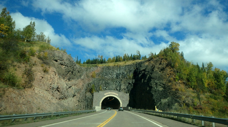 cars driving into and out of Silver Creek Cliff tunnel