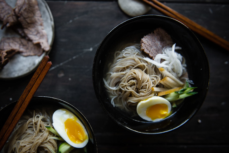 mul naengmyeon (korean cold noodle soup) | two red bowls