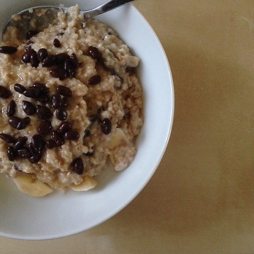 Porridge, with banana, raisins, coconut, maple syrup, and chocolate covered sunflower seeds. Mmm! 😋