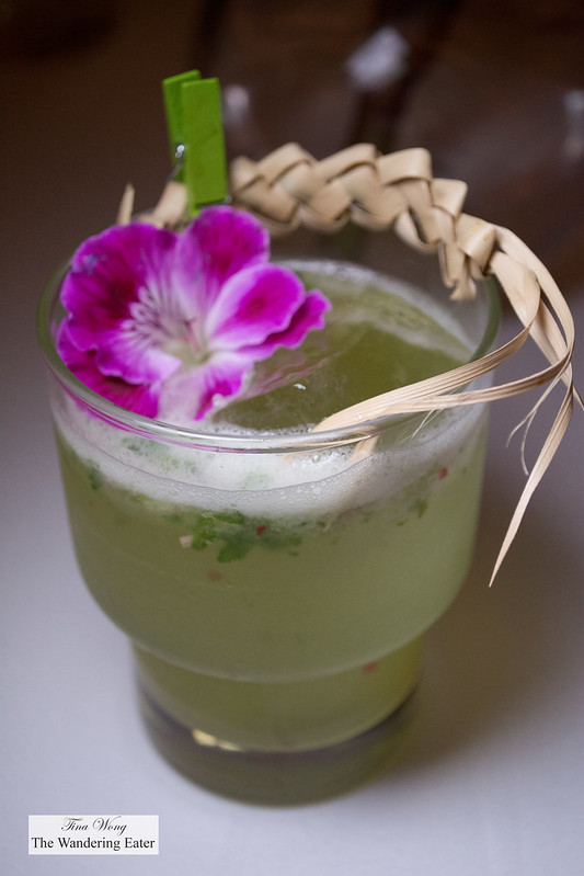 Mezcal, lime, cilantro cocktail with a braided palm bark