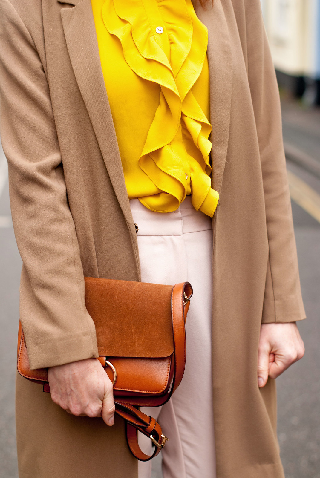 Easter outfit of pastels: Ruffled yellow blouse \ longline camel blazer \ pastel pink peg leg trousers \ tapered pants \ pink ruffle ankle boots | Not Dressed As Lamb, over 40 style