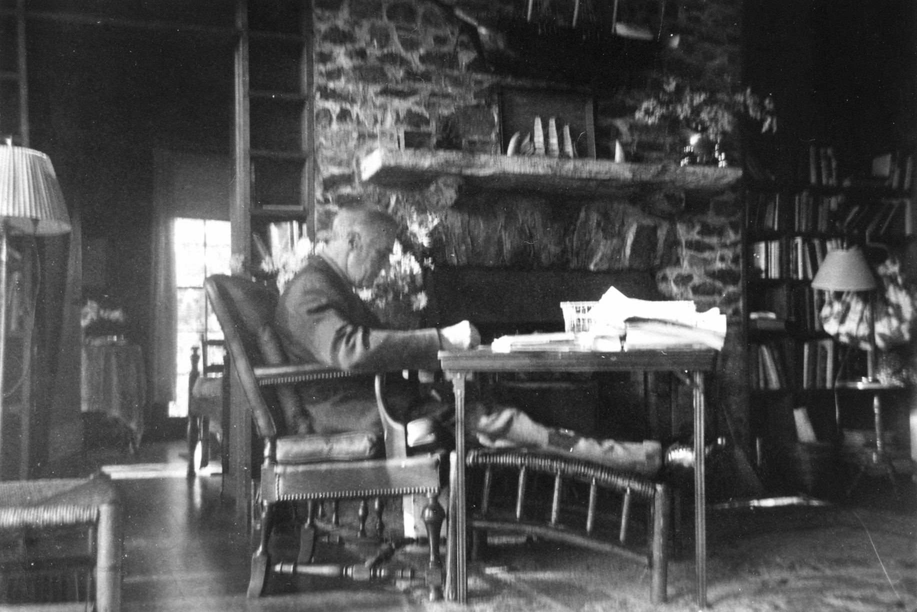 FDR at his work table near the hearth at the Little White House in Warm Springs, Georgia. This photo was taken by his friend Margaret 