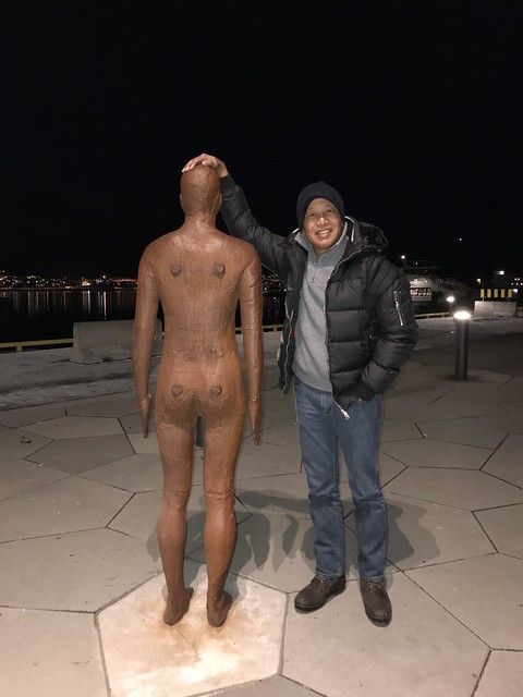 Edmund stands beside the naked statue in Tromso