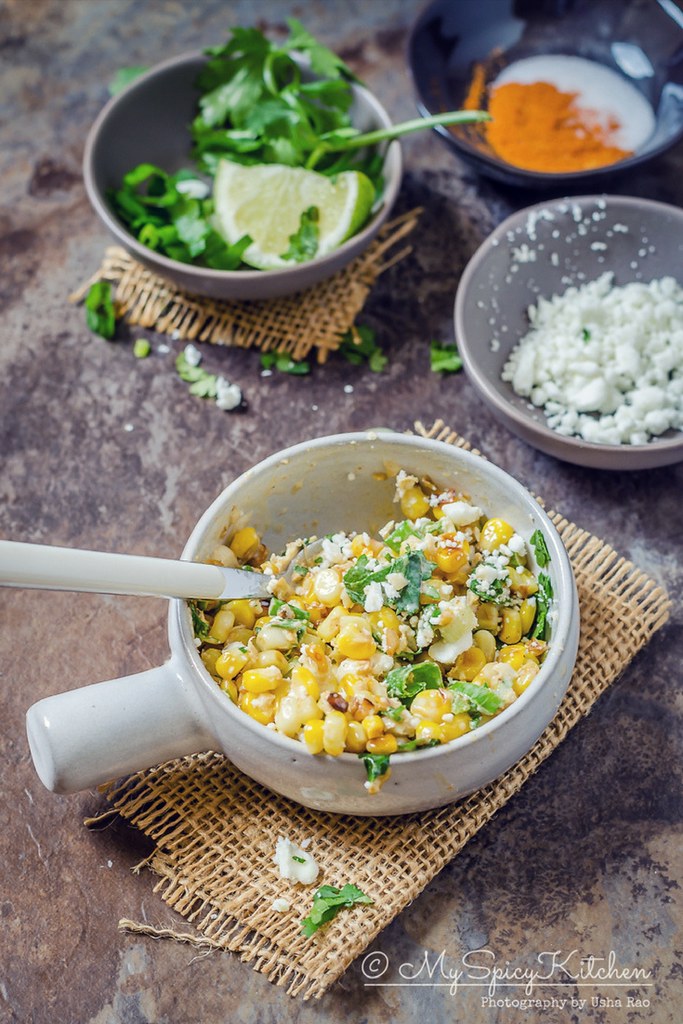 Bowl of corn salad with a spoon.