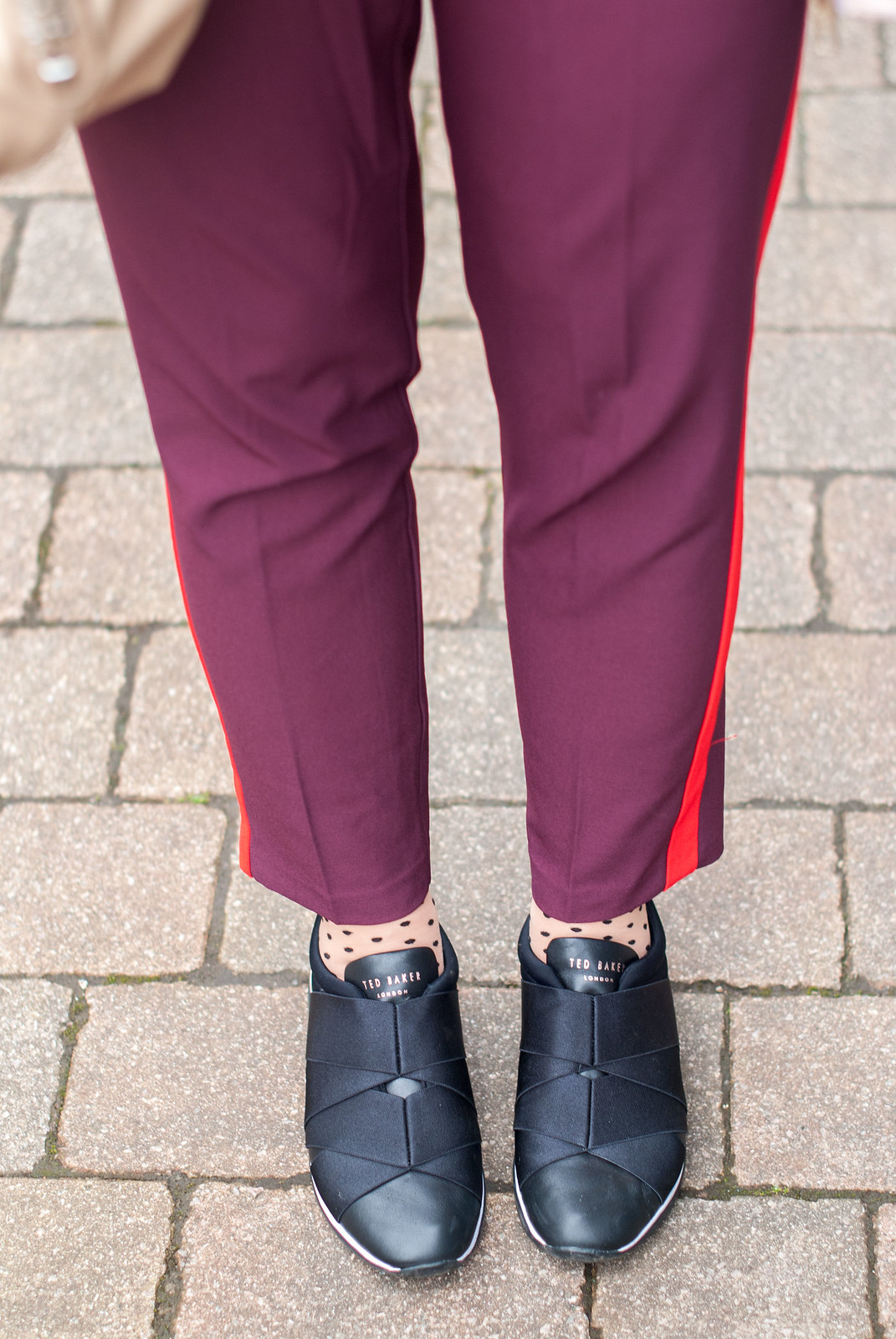 Beating April Showers in Metallics and Warm Colours \ rose gold raincoat \ orange-red sweater \ burgundy and red stripe trousers pants \ Ted Baker Queane trainers sneakers \ polka dot socks | Not Dressed As Lamb, over 40 style