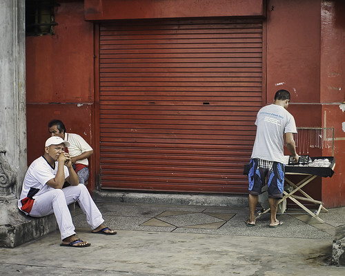 street men sitting vendor watching waiting curious silay city philippines