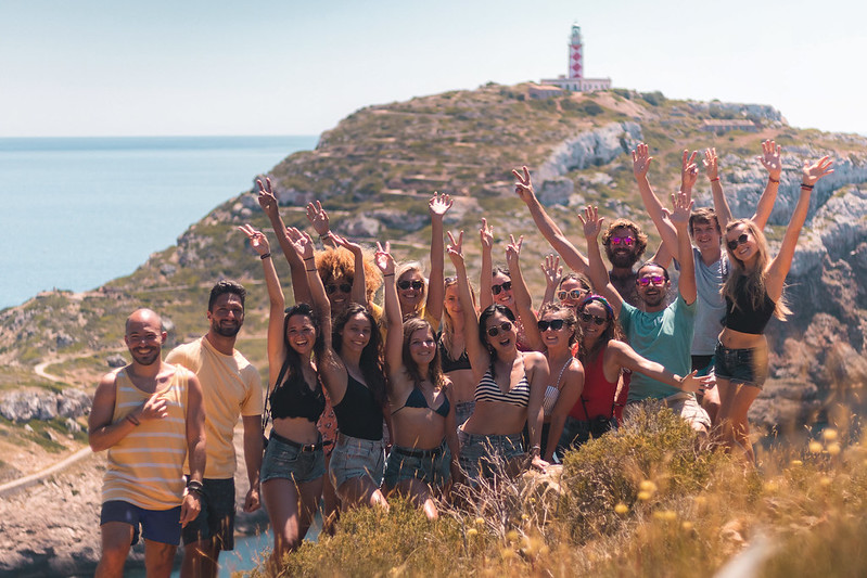 A group of happy people at a Mallorcan lighthouse