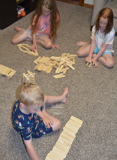 playing with brain blox building planks on the simple moms