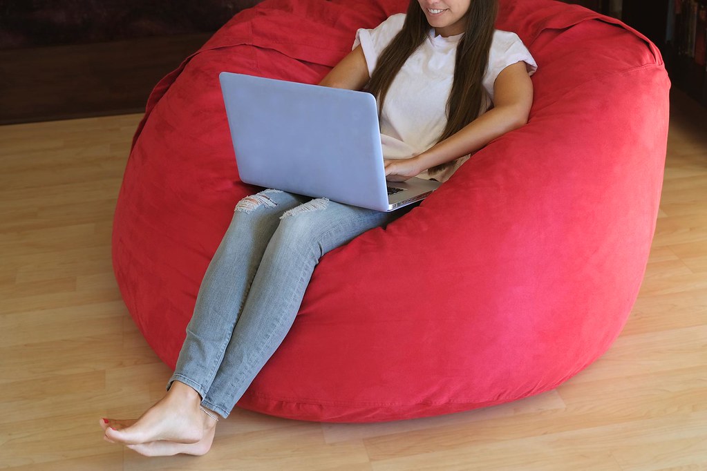 Girl on laptop in bean bag chair