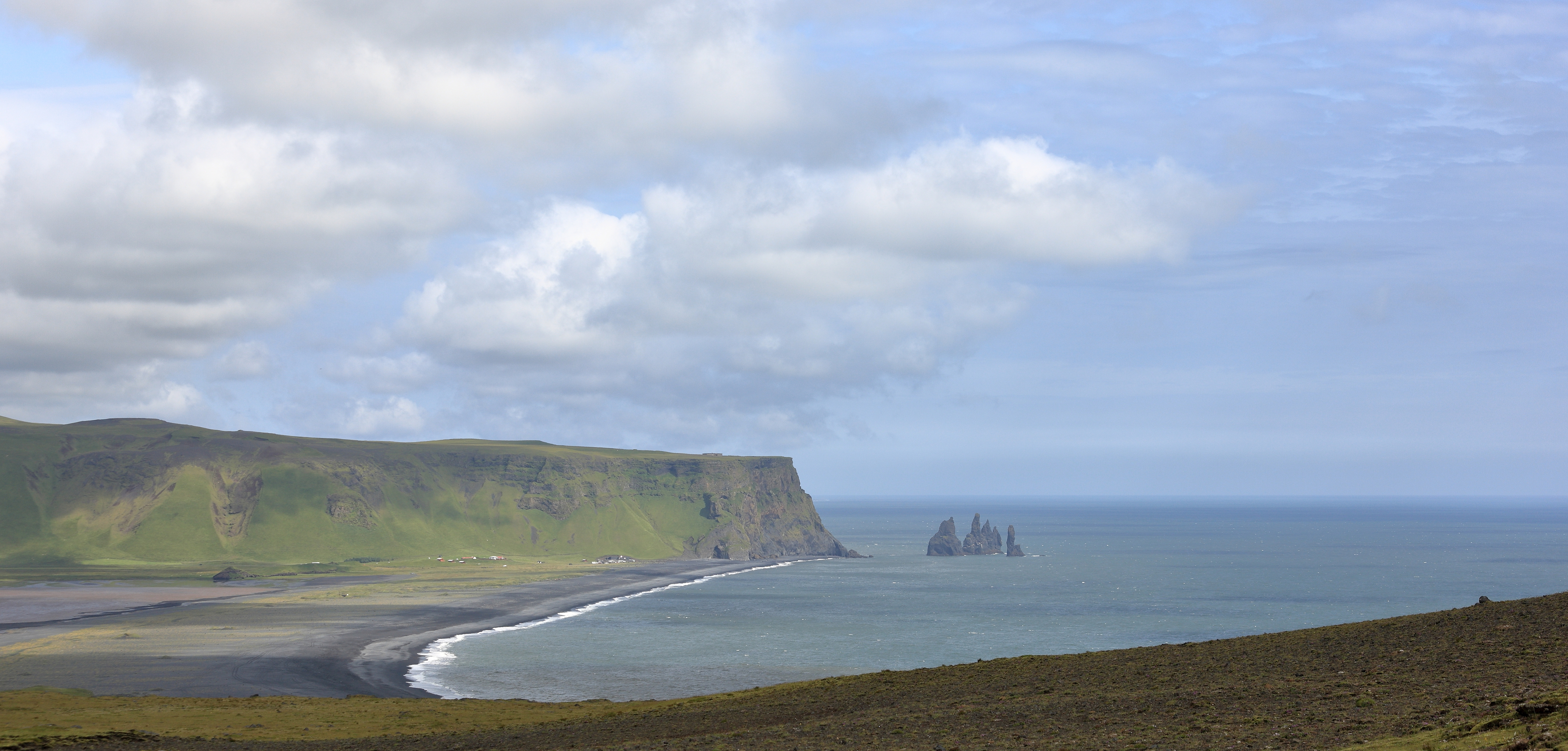 The beach of Reynisfjara and Reynisdrangar, basalt sea stacks, as seen from Dyrhólaey, Iceland. Photo taken on July 20, 2014.