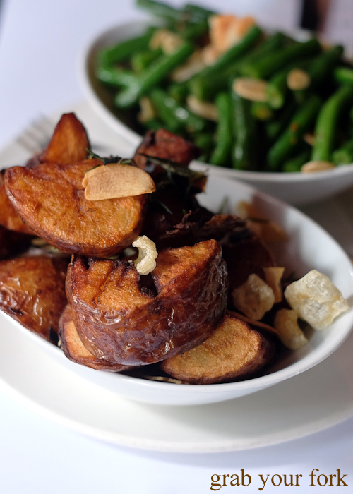 Potatoes with rosemary, garlic and pork crackling at La Rosa The Strand in Sydney