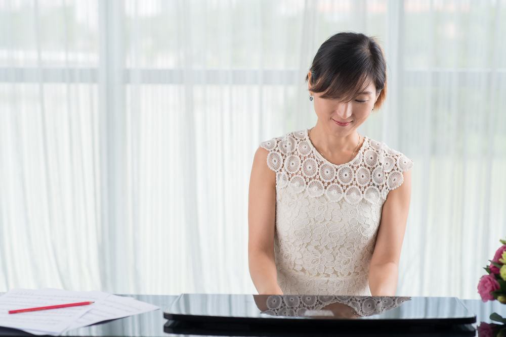 woman practicing piano
