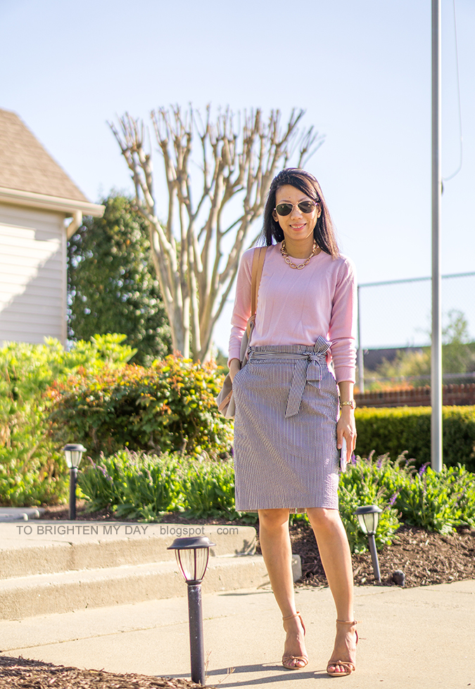 pink sweater, seersucker paperbag pencil skirt with bow tie, beige and gray tote, gold watch, brown sandals with knot detail