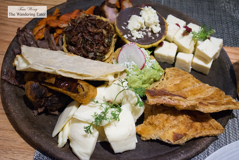 Oaxacan food sampler - Oaxacan cheeses, chicharrón, tostada with black bean puree, fried crickets, pork ribs, skirt steak, chicken