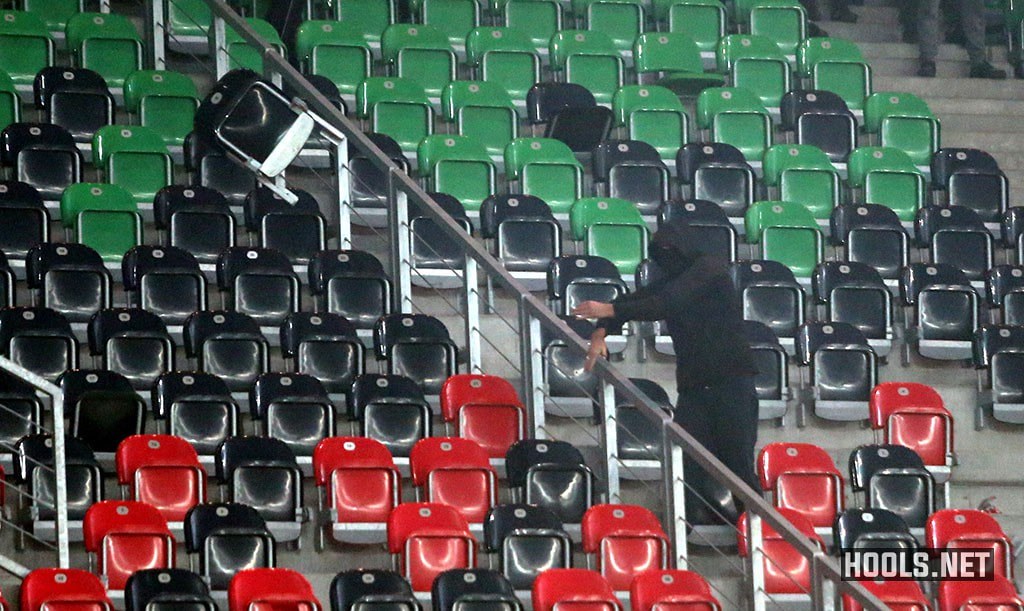 A GKS Tychy fan throws a seat towards cops during the game against Ruch.