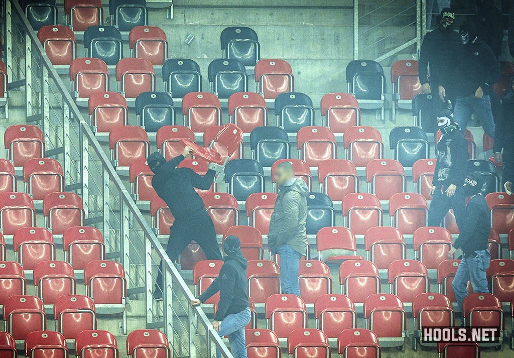 A GKS Tychy fan throws a seat at cops during the game against Ruch Chorzów.