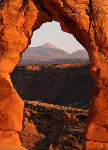 The setting sun turns Delicate Arch red in Arches National Park, Utah, USA