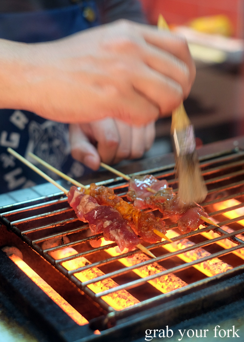 Basting chuan skewers on the barbecue at Granny Wolf BBQ in Central Park Mall Sydney