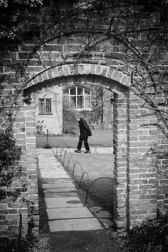 england warwickshire packwoodhouse nationaltrust garden doorway wall path walking woman plants windows bw
