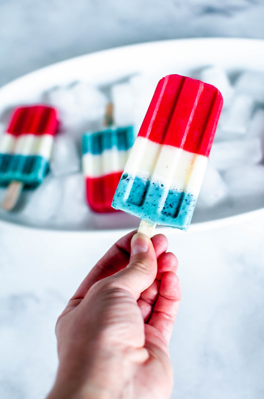 Vanilla frozen yogurt, tart lemonade and fruit combine to make these super fun and festive Creamy Lemonade Bomb Pops. Enjoy one or three while watching your favorite fireworks display this year. 