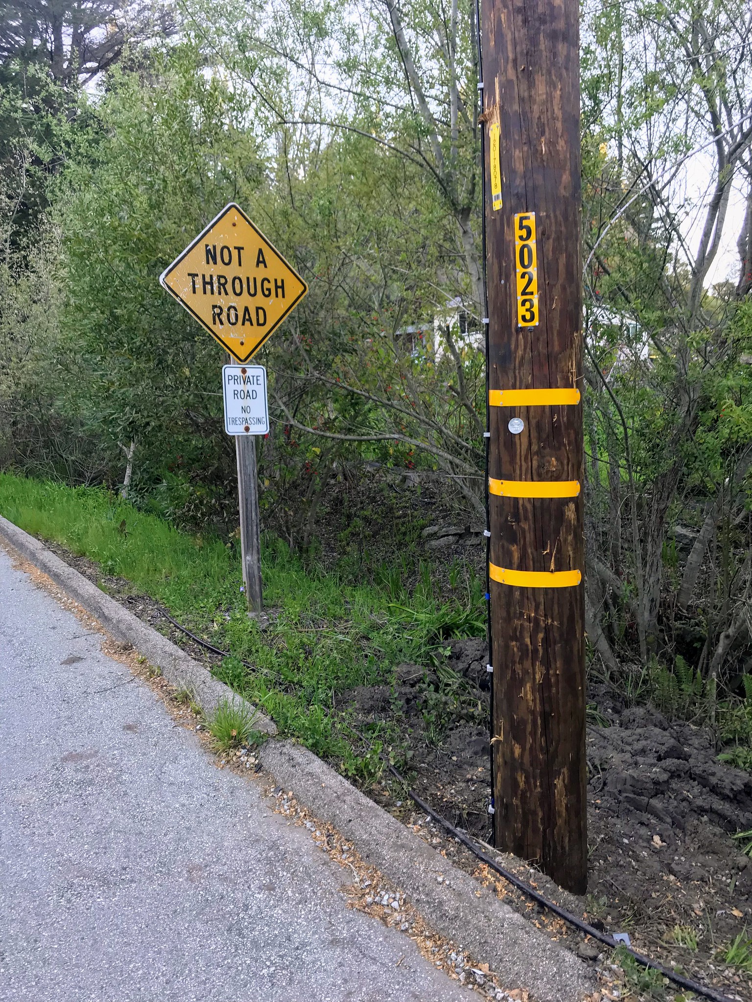 The pole is close to the road sign
