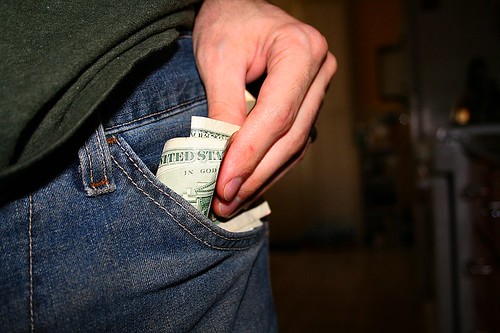 US dollars in jeans pockets