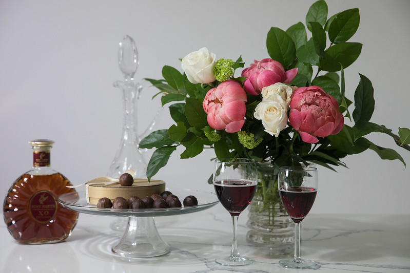 Champagne Truffles, Remy Martin Louis XIII XO Cognac and bouquet of Coral Sunset semi-double peonies and ivory rosies