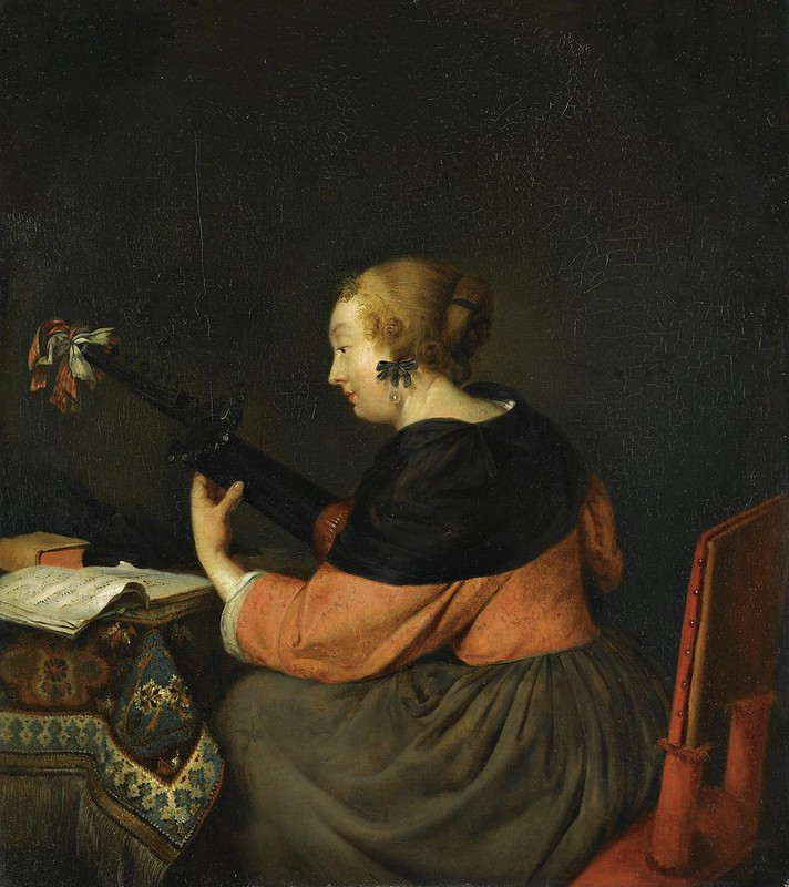 Follower of Gerard ter Borch - A lady seated at a table playing a lute