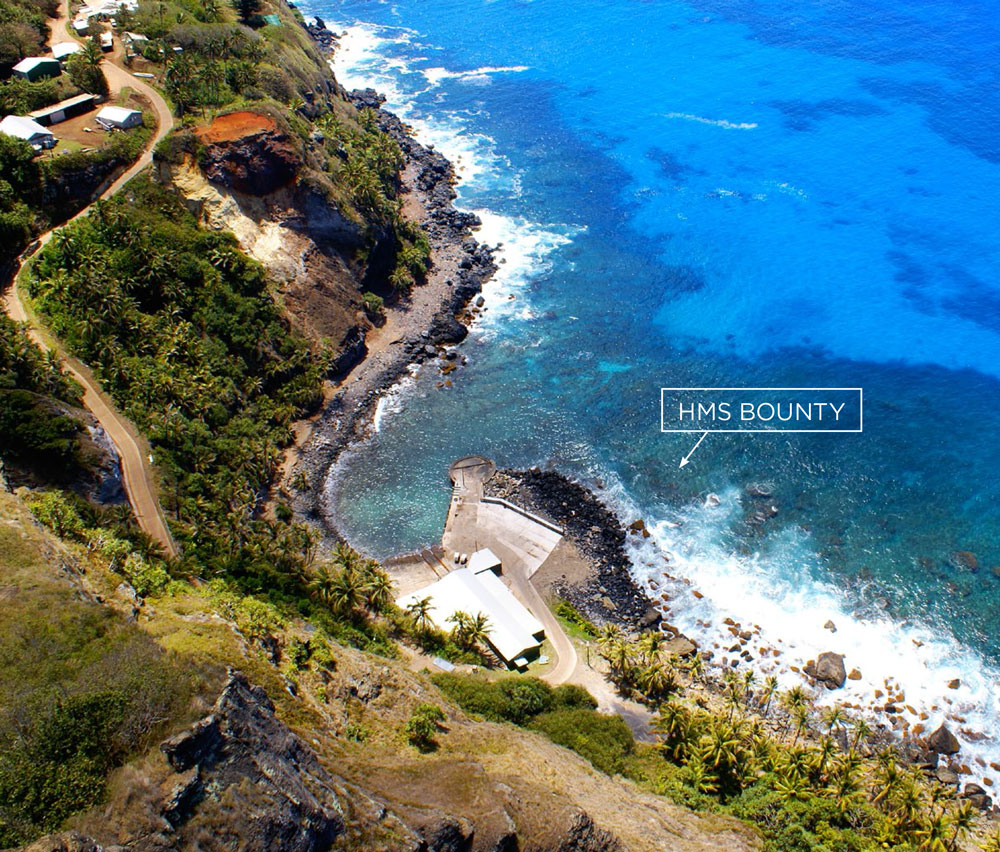 Aerial view of the jetty at Bounty Bay on Pitcairn Island, showing the location of HMAV Bounty wreckage.