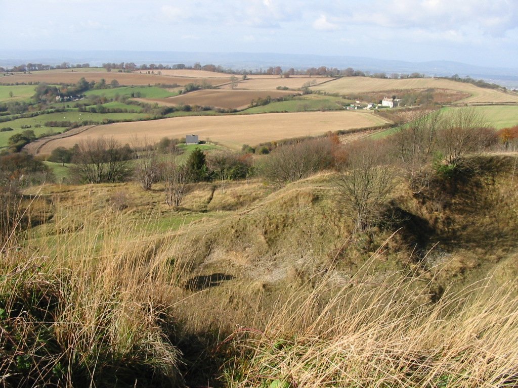 A view from the Painswick Beacon in Gloucestershire, England. The view is in the direction of Gloucester, approximately due North of this position. The Earthen banking in the foreground is the remnants of the iron age defenses from when the site was a hill fort. Photo taken on November 4, 2002. 