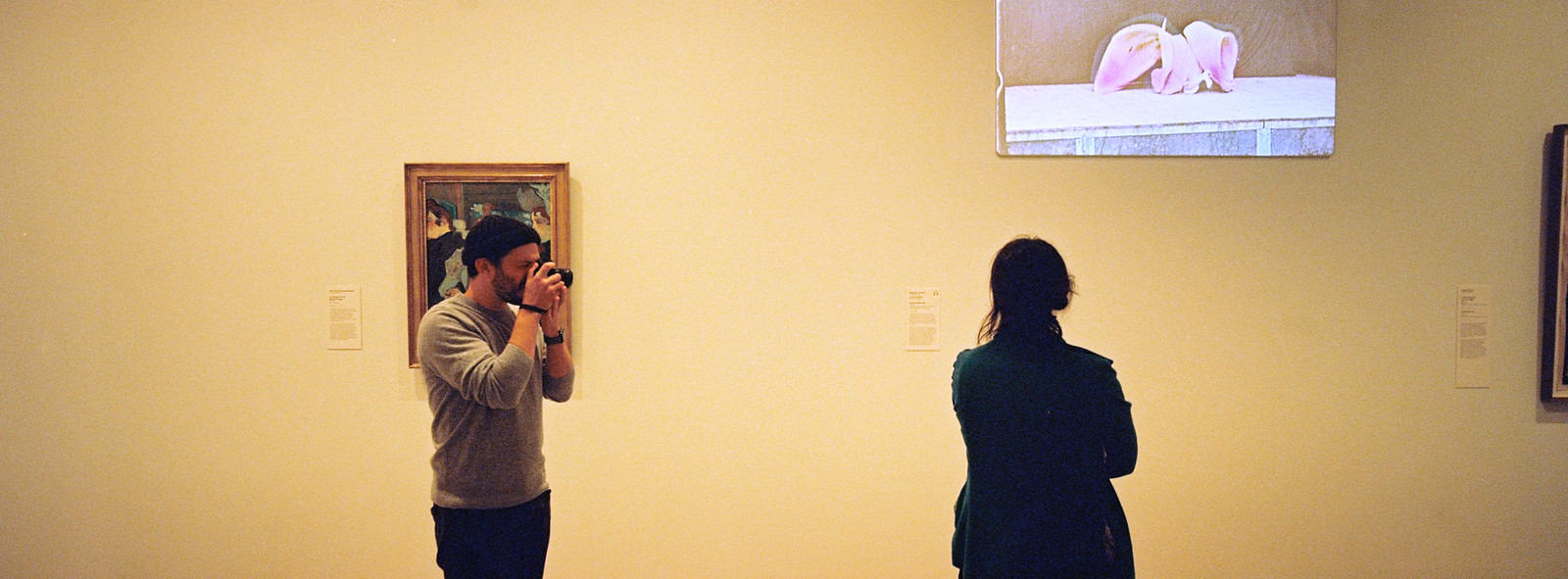 Tim shoots Anna, Anna looks at art.
