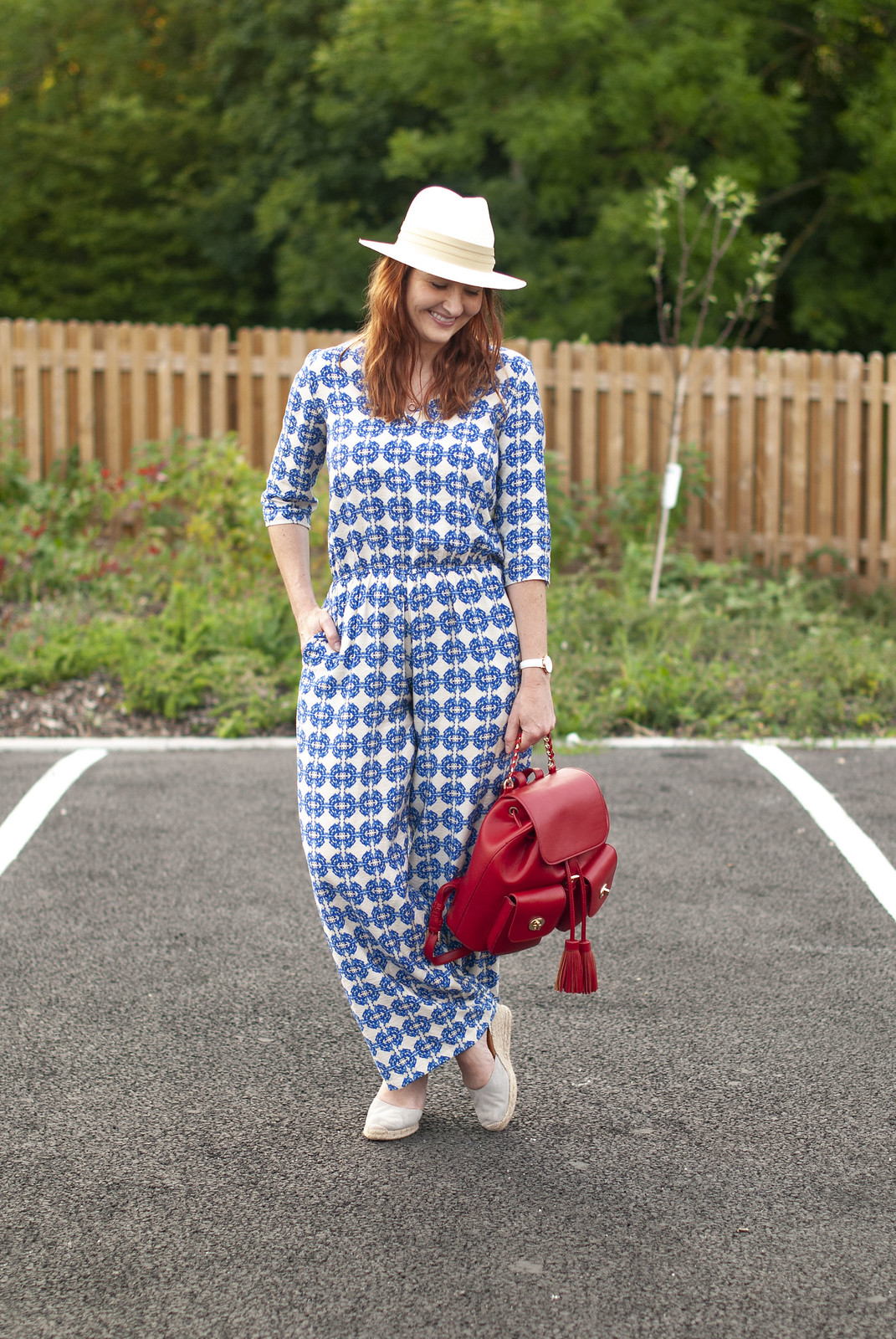 Like Nothing Else in the Shops: A Blue Patterned Jumpsuit \ grey wedge espadrilles \ cream Panama hat \ red backpack | Not Dressed As Lamb, over 40 style