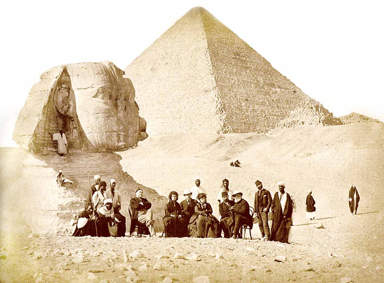 French archaeologist Auguste Mariette (seated, far left) and Emperor Pedro II of Brazil (seated, far right) with others surrounded by local Egyptians during the Emperor's trip to Egypt in the end of 1871. Behind them can be seem the Great Sphinx of Giza and the Giza Necropolis.