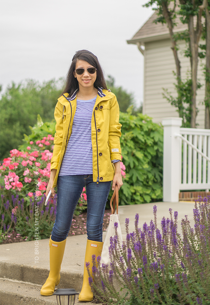 yellow rain jacket, periwinkle blue striped top, jeans, canvas tote, yellow rain boots