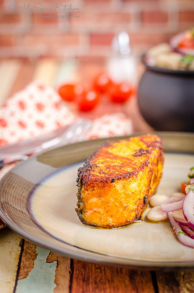 A plate of pan seared tandoori salmon with some lima beans salad. It is a healthy, quick and easy recipe