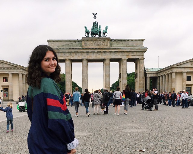 Student standing in front of the Brandenburg Gate in Berlin. 