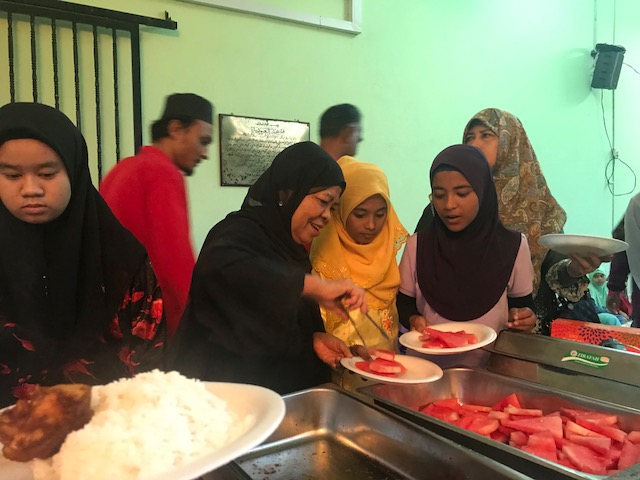 Datuk Rosnah Majid serves up food to young guests at Masjid Al-Ubudiah in Ampang on the first day of Ramadan