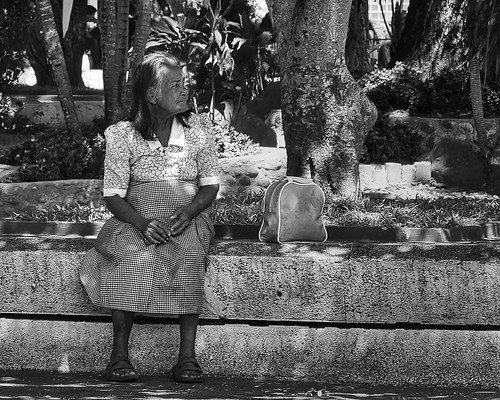 elderly lady relaxing sitting park street silay city philippines