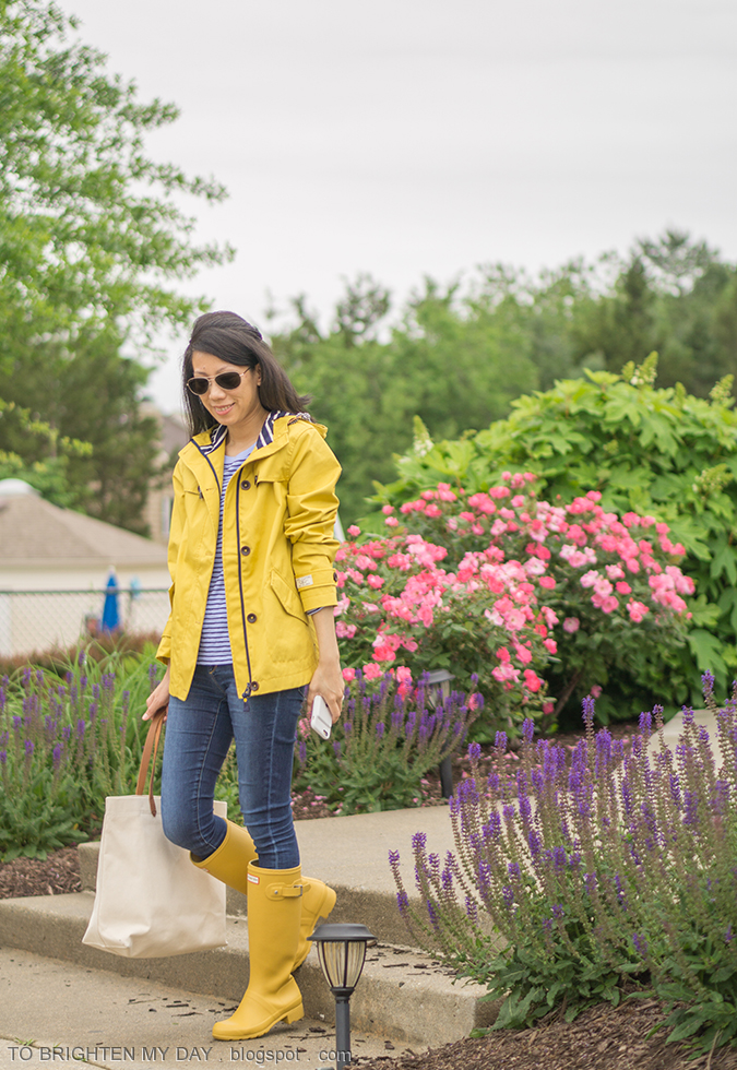 yellow rain jacket, periwinkle blue striped top, jeans, canvas tote, yellow rain boots