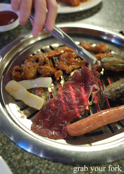 Cooking all-you-can-eat Korean barbecue at Charcoal Mine Barbecue House in Parramatta Sydney