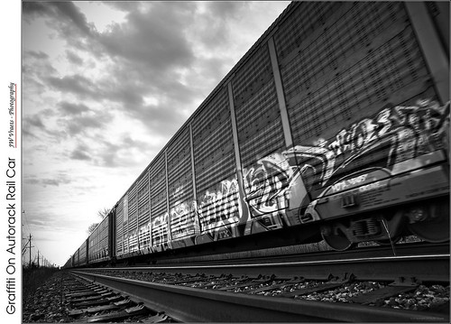 grimsby train railcar autorack carcarrier tracks perspective leadinglines lowangle cloudy graffiti blackandwhite bw monochrome opensource rawtherapee gimp olympus e3 fourthirds 43 digitalzuiko1260mmf284